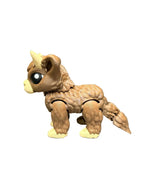 Toy Highland Cow with brown and beige color scheme on a white surface